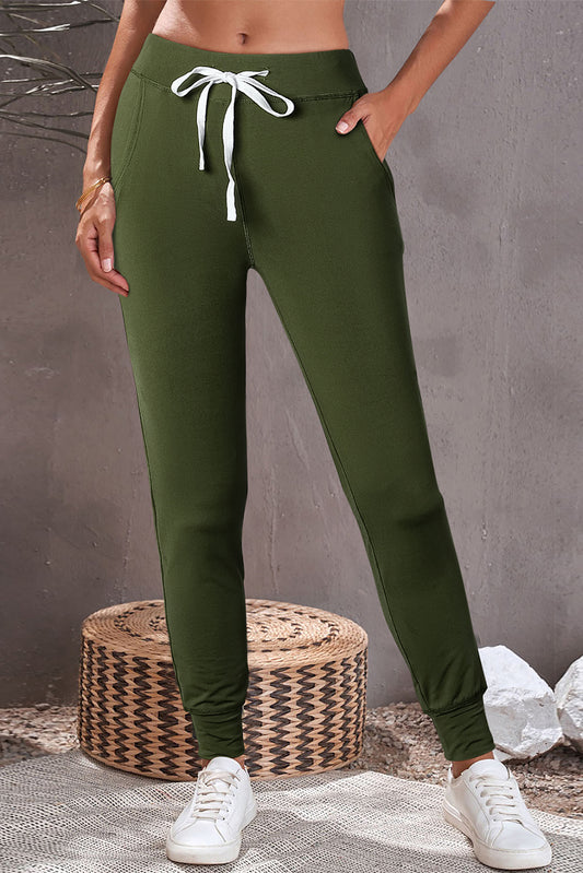 Moss green joggers with drawstring.