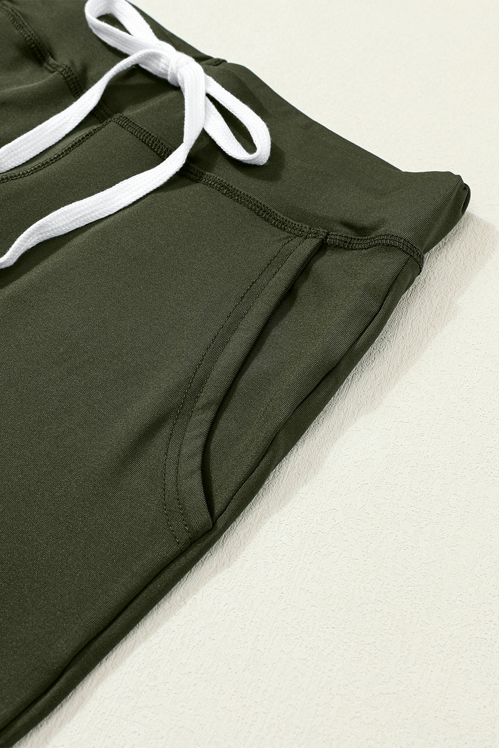 Moss green joggers with drawstring.