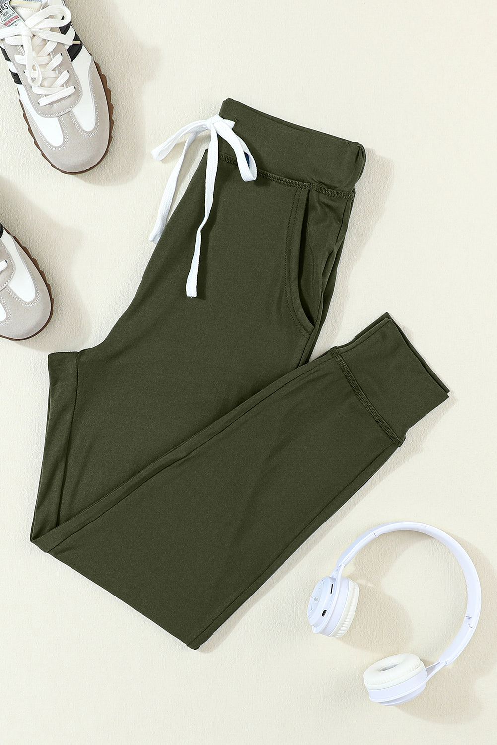 Moss green joggers with drawstring.