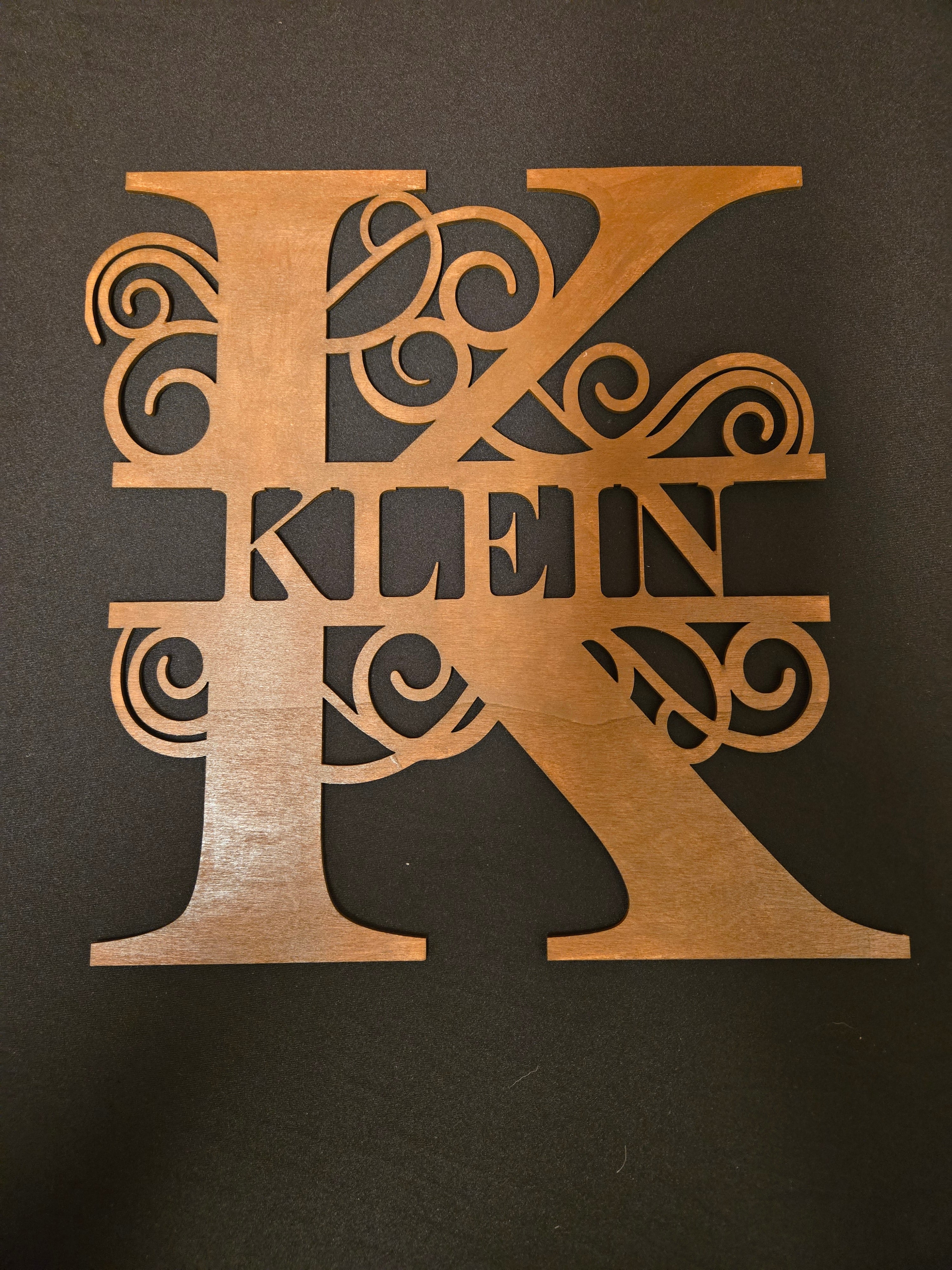 Letter K with the last name Klein in the middle of the letter. 